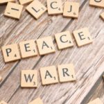 Conflict Resolution - The word peace written on wooden letters