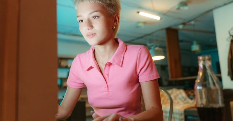 Keywords - Woman in Pink Polo Shirt Sitting at PC