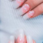 Professional Ethics - A woman's hands with white and pink nails