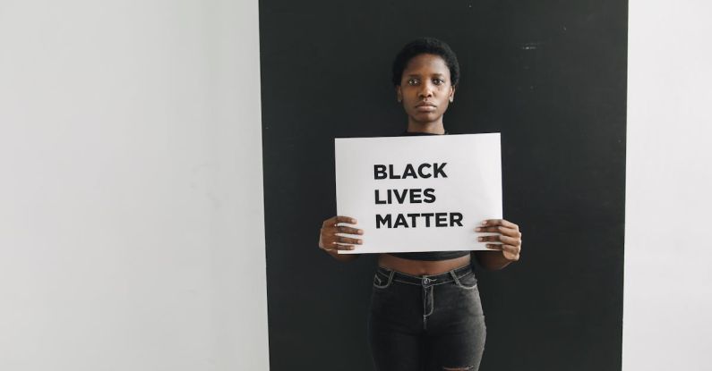 Inclusion - A Woman Holding a Card with Words Black Lives Matter